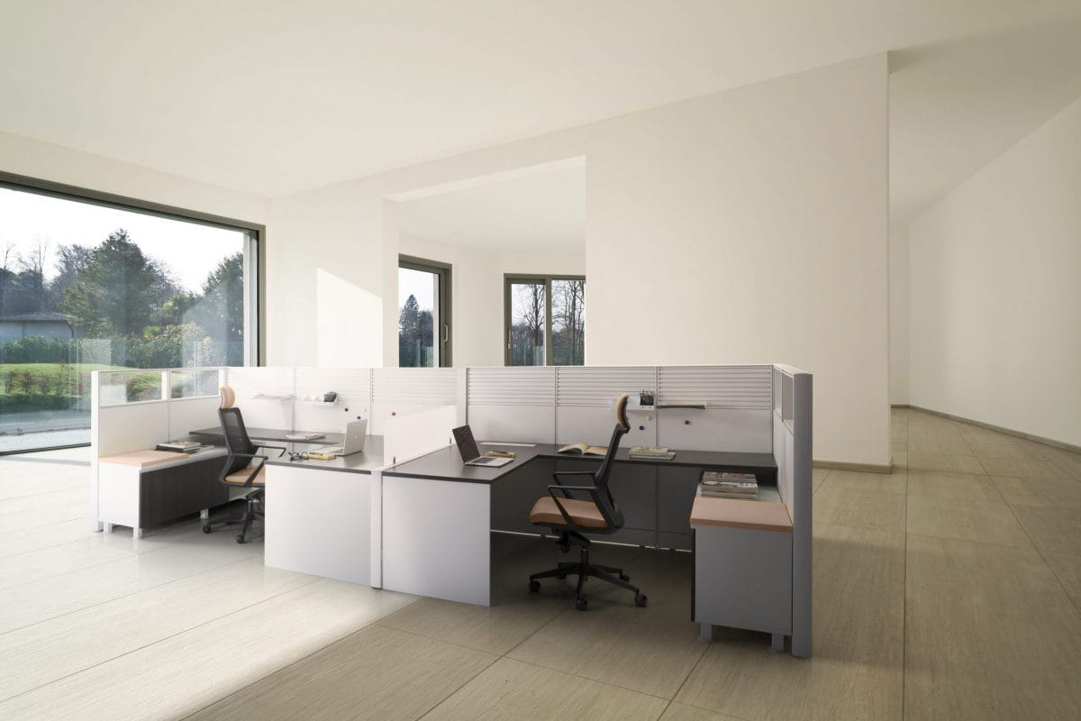 Panel system construction: four worksurfaces cantilevered off a continuous panel spine, with a slatted rail and a clear top screen above the solid panel section.