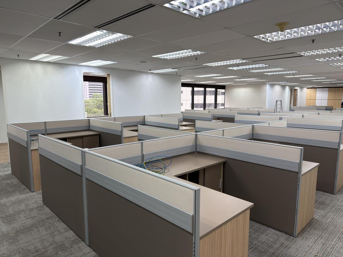 Waist-height fabric partitions folding each desk into its own bounded bay, a UA Office installation.